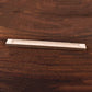 Wooden 23cm incense stick holder on a dark wooden surface, showcasing a minimalist design for home decor.